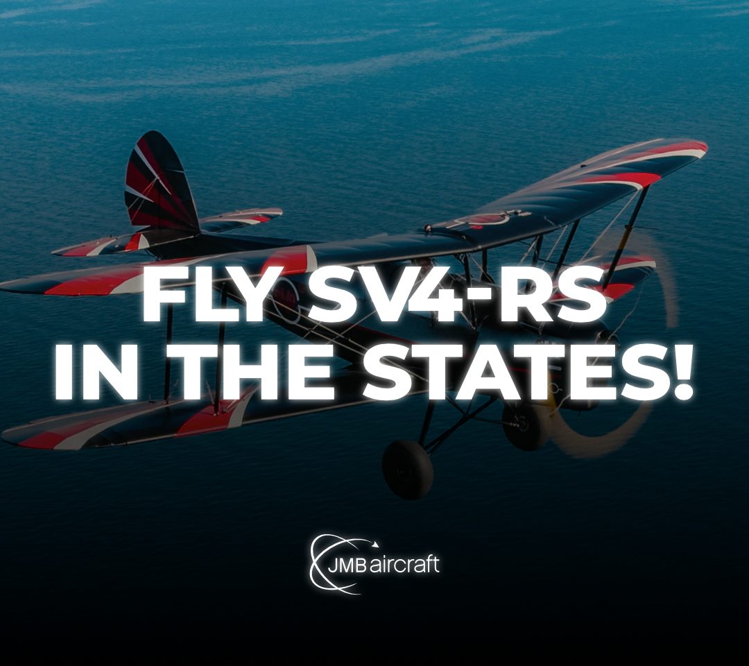 JMB SV4 biplane flying over mountains
